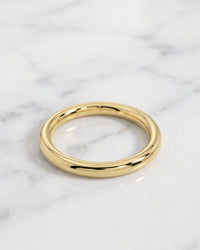 Eyebrow hoops - plain 14k yellow gold seam ring hoop on white marble