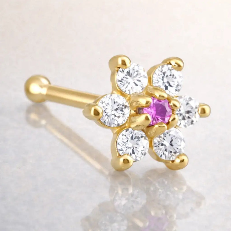 14K yellow gold CZ flower nose bone with pink tourmaline CZ center stone, angled view