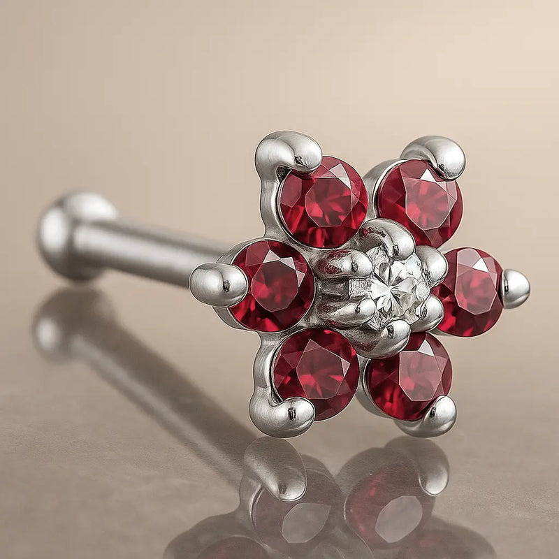 14K white gold flower nose bone with red CZ petals and clear CZ center, angled product view
