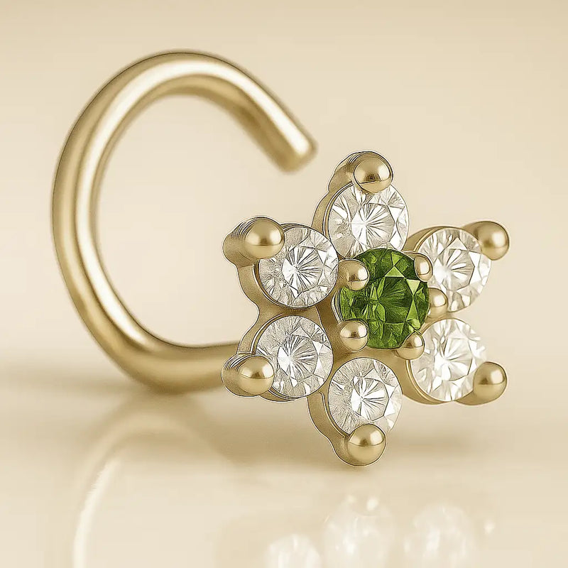 14K yellow gold CZ flower nose ring twist with green center CZ, angled view showing screw post