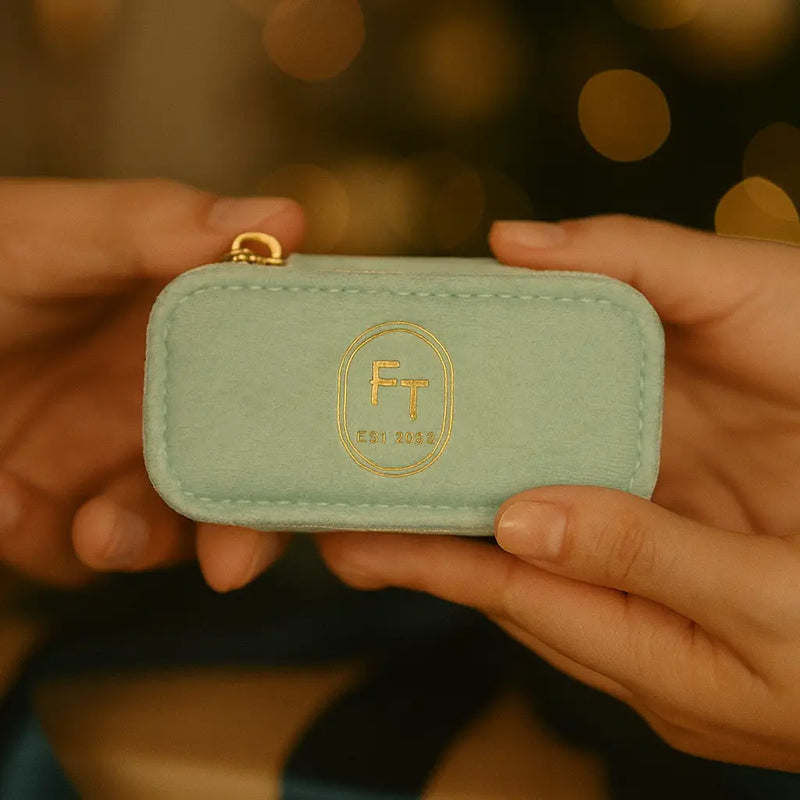 FreshTrends mint green travel jewelry box held in both hands, showing compact size for travel