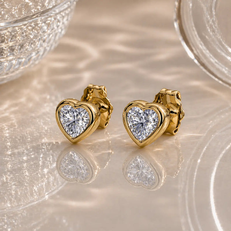 14k yellow gold white sapphire heart stud earrings pair, clear stones with brilliant facets, angled view