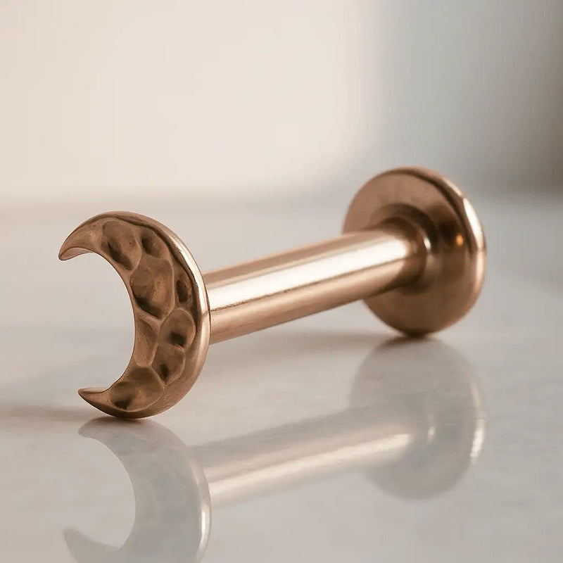 14K rose gold hammered crescent moon flat back labret, angled view showing post and flat disc back