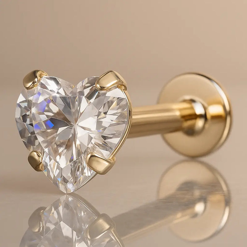 14k yellow gold flat back labret with prong-set heart CZ, angled studio shot showing flat disc back