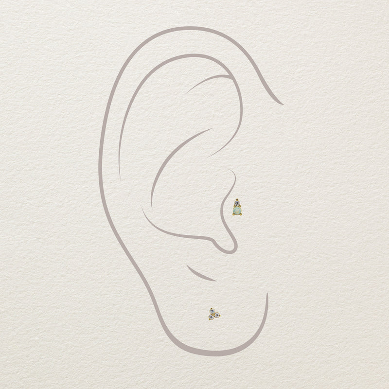 Illustration of opal and diamond gold stud end placed in cartilage and lobe ear piercings