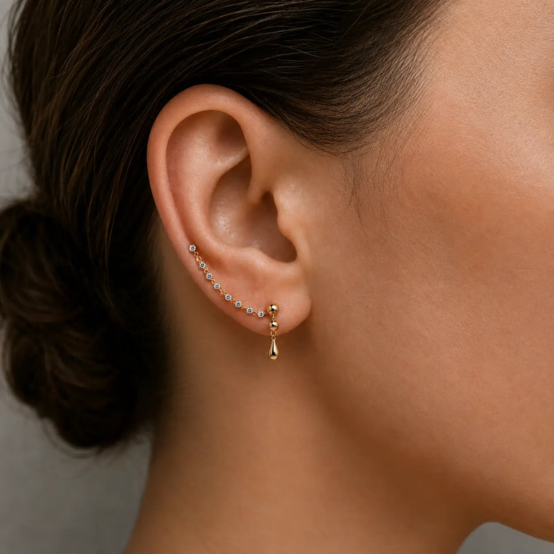 14K yellow gold CZ Lyra earring connector worn between two ear piercings, shown on model for fit