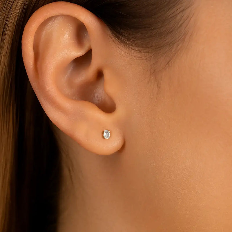 3mm oval diamond flat back earring worn in lobe piercing, showing delicate fit and scale on model