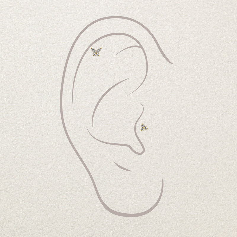 Placement diagram showing diamond butterfly studs at helix and conch positions on illustrated ear