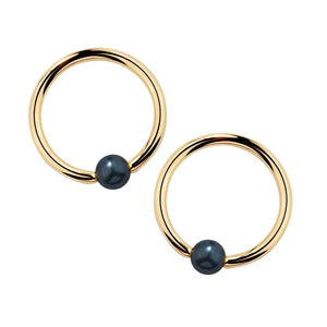 Pair of 14k yellow gold captive bead nipple rings with cultured peacock pearl beads, front view