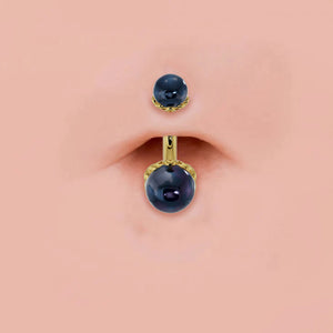 Black Akoya pearl 14k gold navel ring shown in pierced belly button, scroll setting detail visible