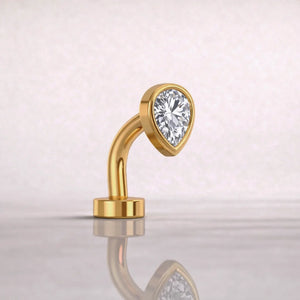 Side profile of 14k yellow gold petite teardrop floating belly ring with CZ, showing curved barbell shape