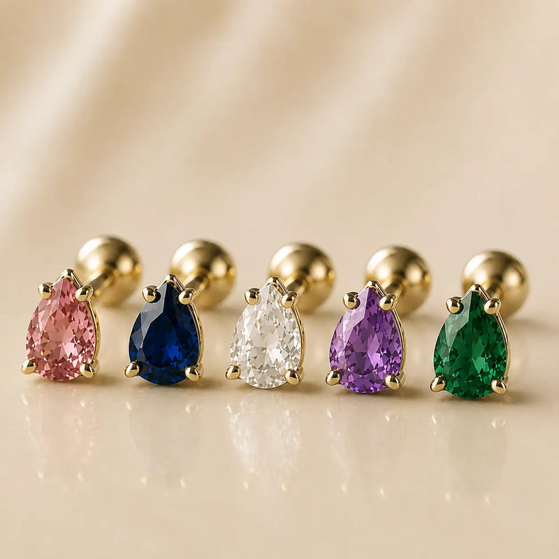 Five pear-cut gemstone flat back studs in 14k gold showing pink, blue, clear, purple, and green color options
