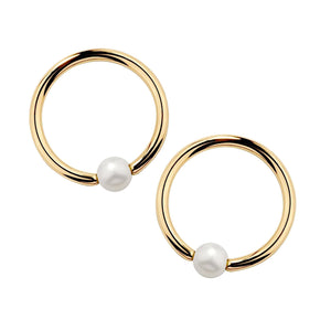 Pair of 14k yellow gold captive bead nipple rings with white cultured pearl beads, front view