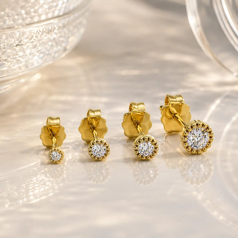 14K yellow gold diamond perlage stud earrings in three sizes showing bead bezel setting comparison