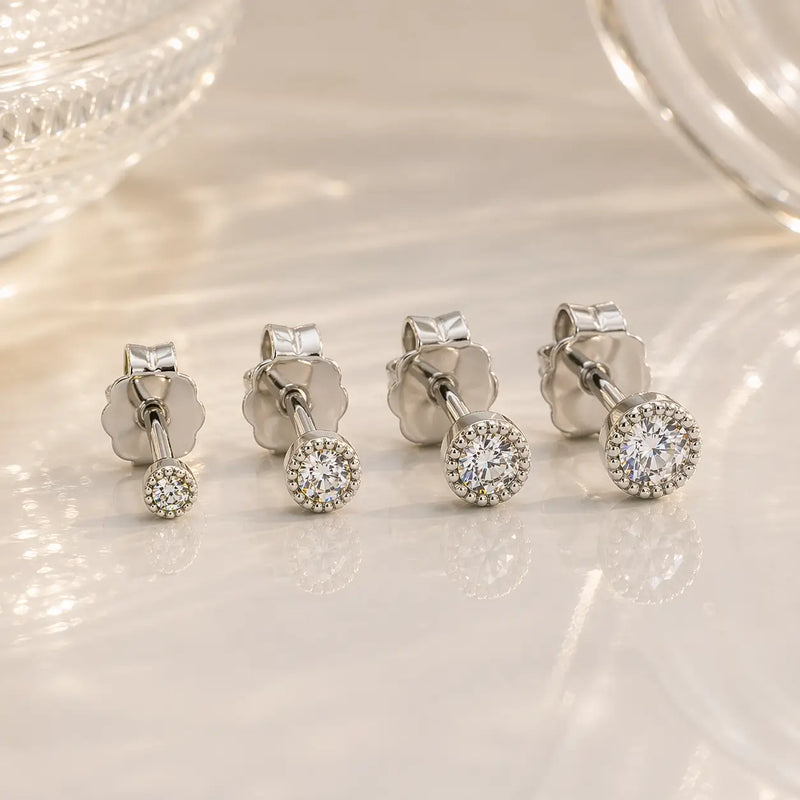 14K white gold diamond perlage stud earrings in three sizes showing graduated bead bezel settings