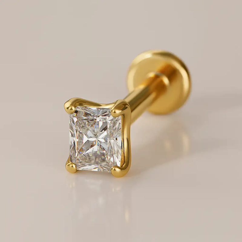 14k yellow gold radiant-cut diamond flat back labret stud, angled view showing four-prong setting and disc