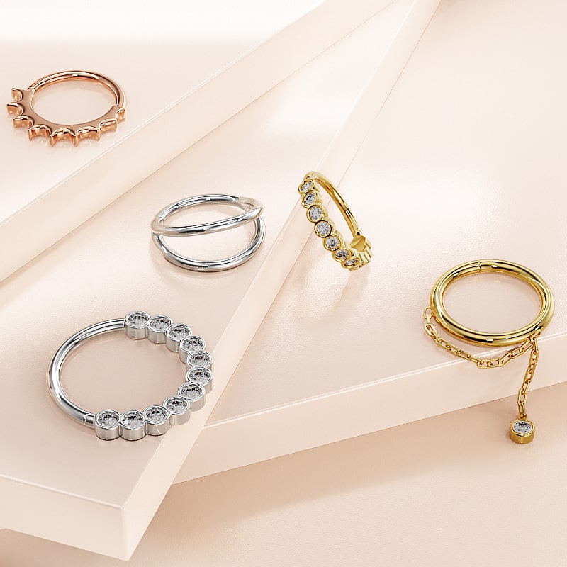 14k yellow gold Shanti dangle seam ring shown alongside other gold cartilage ring styles