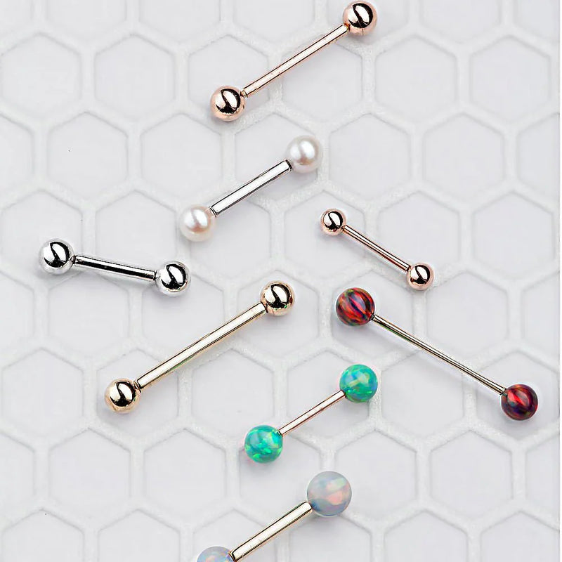 Assortment of straight barbell nipple rings in rose gold, white gold, and yellow gold with opal and pearl ends