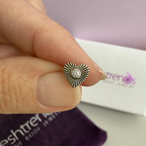 14k white gold diamond sunburst heart flat back stud held between fingers for size reference