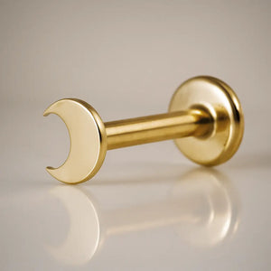 14k yellow gold crescent moon flat back labret stud, angled view showing post and flat disc backing