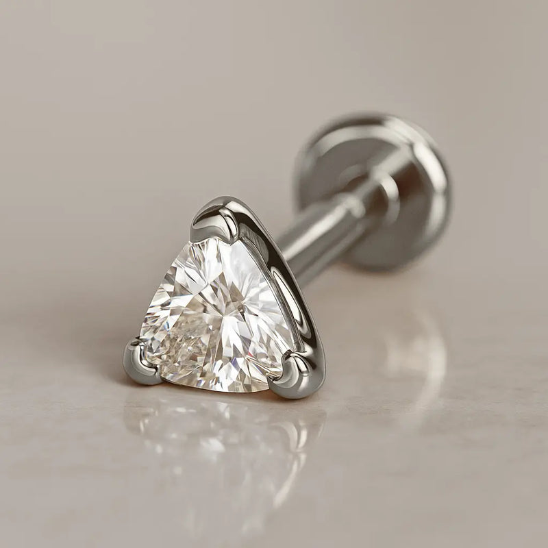 14k white gold 3mm trillion diamond flat back labret stud, angled lifestyle shot on neutral surface