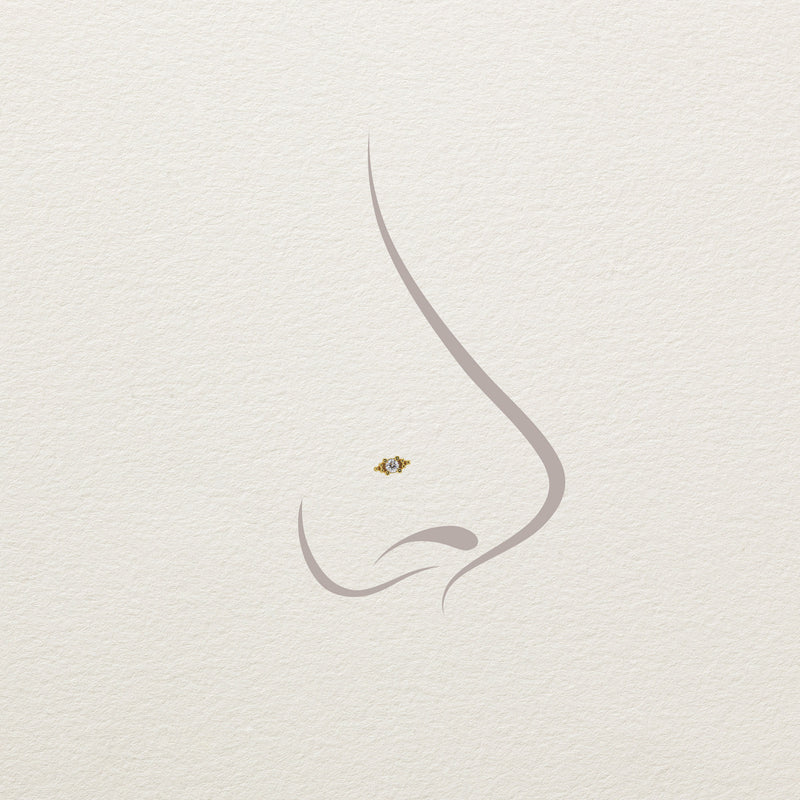 14k yellow gold Bali Blossom diamond threadless end shown on illustrated nose piercing placement