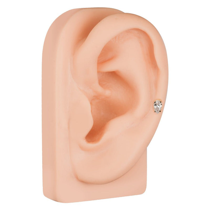14k yellow gold pear diamond stud shown in lobe on silicone ear model, angled side view for fit reference