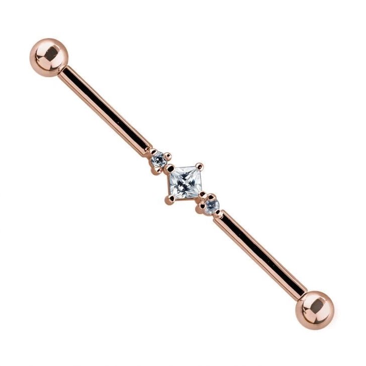 14K rose gold industrial barbell with triple cubic zirconia gems, angled product view