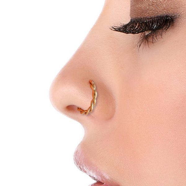 14K yellow gold twisted nose hoop worn in side-profile nostril piercing, showing hoop fit