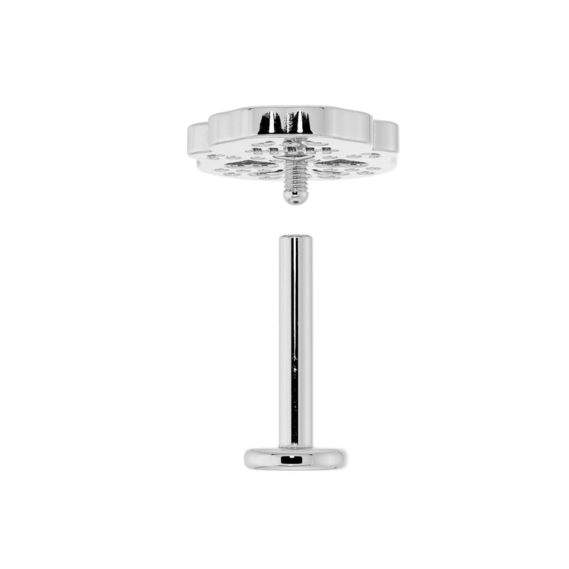 Disassembled flat back labret showing threaded skull top and flat disc barbell post in white gold tone