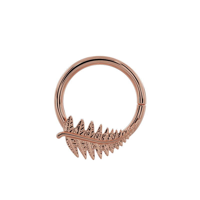 Low-angle view of 14K rose gold fern leaf seam ring showing engraved frond detail and clasp