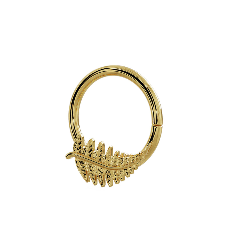 Angled view of 14K yellow gold fern leaf seam ring showing charm from a higher perspective