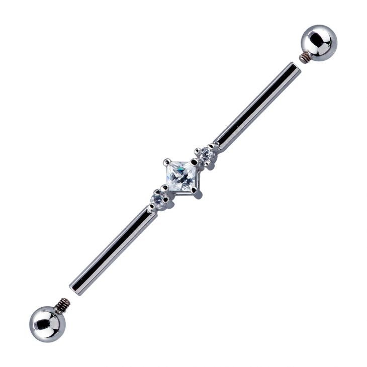 White gold triple CZ industrial barbell with internally threaded ball ends detached, showing threading detail