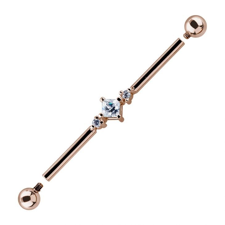 14K rose gold triple CZ industrial barbell with threaded ball ends removed, showing internal threading