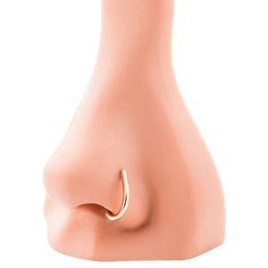 14K rose gold faux hoop nose ring shown in nostril piercing on mannequin nose for fit reference