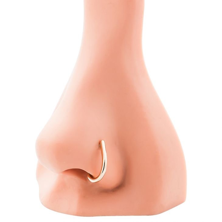 14K rose gold faux hoop nose ring shown in nostril piercing on mannequin nose for fit reference