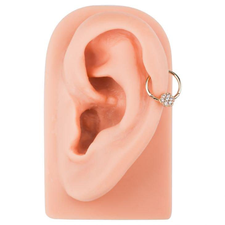 14K gold diamond flower clicker ring styled in a helix or daith ear piercing on ear model