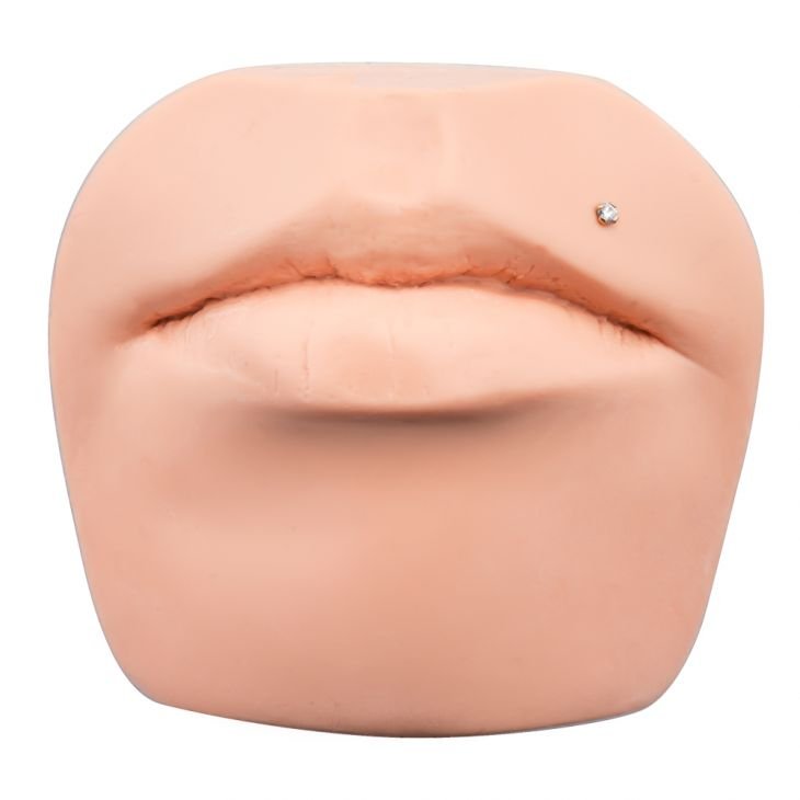 3mm diamond gold flat back labret stud shown in Monroe piercing on silicone lip display model