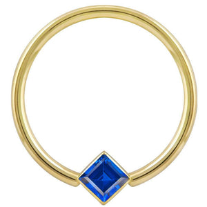 14k yellow gold fixed bead ring with blue princess-cut CZ in corner bezel mount, front view