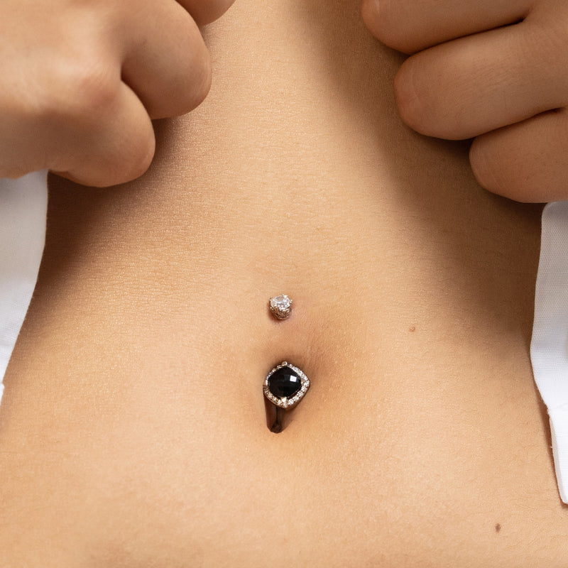Black onyx and diamond 14k rose gold navel ring shown in pierced belly button for fit reference