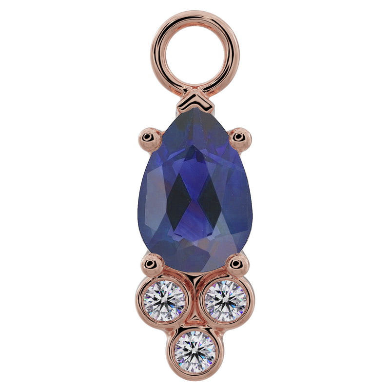 14K rose gold pear-cut blue sapphire piercing charm with three bezel-set diamond accents, front view