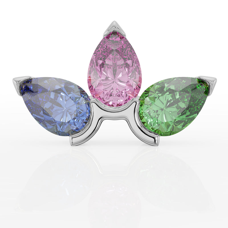 Front close-up of white gold three pear-gem cluster showing tanzanite, pink sapphire, and tsavorite facets