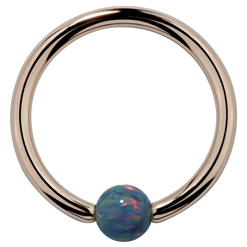 14K rose gold captive bead ring with teal simulated opal bead, front view on white background