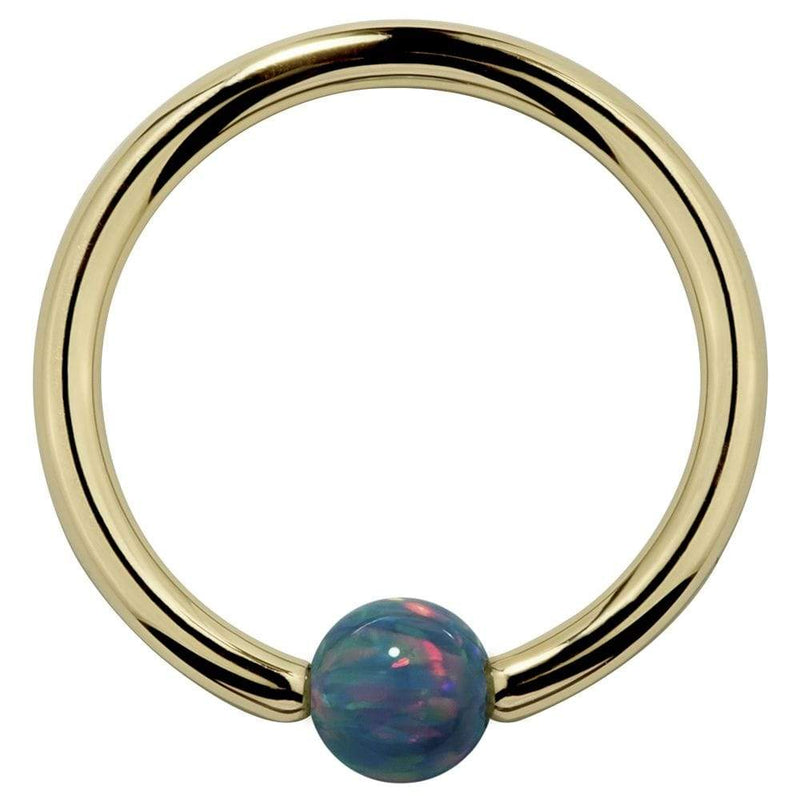 14K yellow gold captive bead ring with teal simulated opal bead, front view on white background