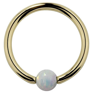 14K yellow gold captive bead ring with white opal ball, front view on white background