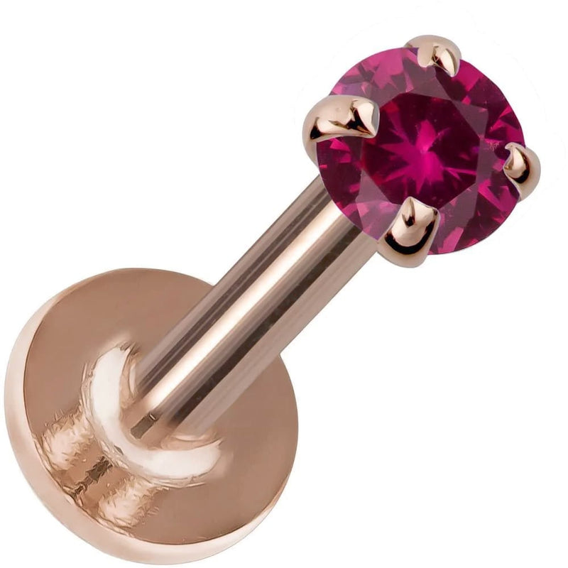 14K rose gold flat back labret with 3mm rhodolite garnet in four-prong setting, angled product view