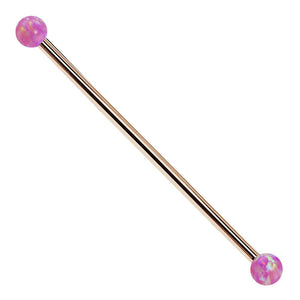 14k rose gold industrial barbell with purple synthetic opal ball ends, front view on white background