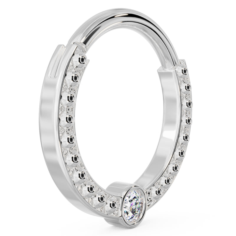 Angled view of larger 14k white gold dome bead clicker ring highlighting polished bead detail