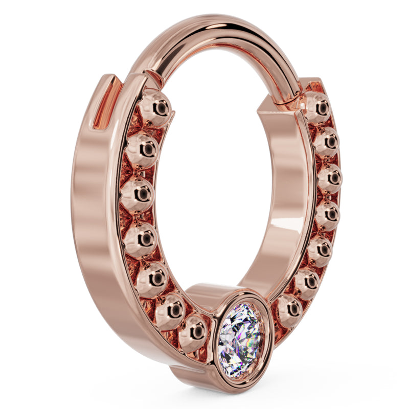 Side profile of 14k rose gold dome bead clicker ring showing warm tone and bezel-set diamond