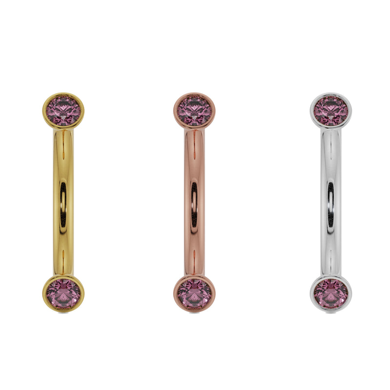 Pink sapphire bezel curved barbell in 14K yellow gold, rose gold, and white gold side by side